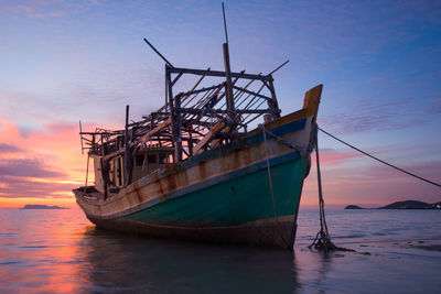 Boat moored on sea against sky