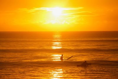 Scenic view of sea against orange sky