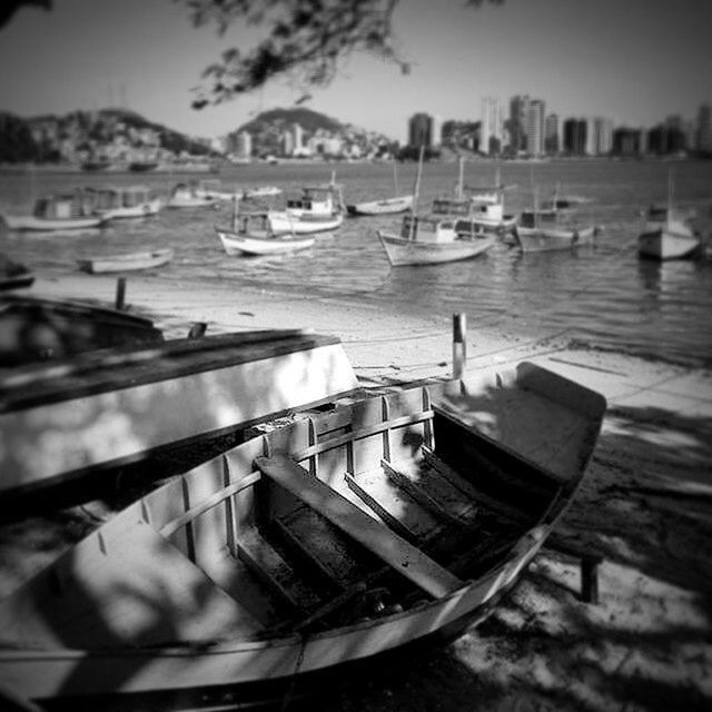 moored, nautical vessel, water, boat, transportation, mode of transport, lake, focus on foreground, sea, river, harbor, sky, nature, outdoors, reflection, tranquility, no people, in a row, absence, selective focus