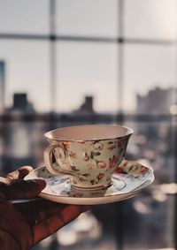 Close-up of hand holding tea cup