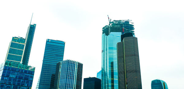 Low angle view of buildings in city against clear sky