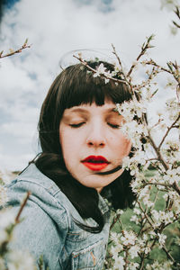 Portrait of beautiful woman against plants