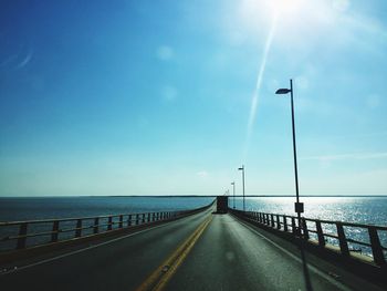 Rear view of truck on road over sea