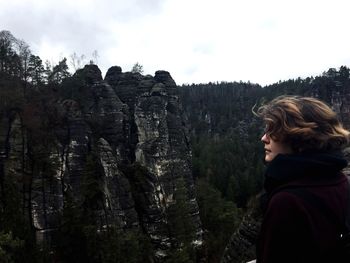 Rear view of woman standing on rock