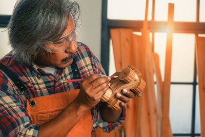 Close-up of man working at workshop