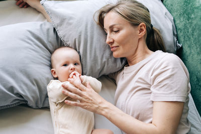 Portrait of cute baby boy sleeping on bed at home