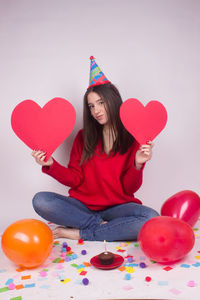 Rear view of woman with heart shaped balloons
