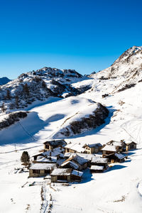 View of the village of grevasalvas, and lake sils, in engadine, switzerland, in winter.