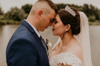 Side view of bride and bridegroom holding hands