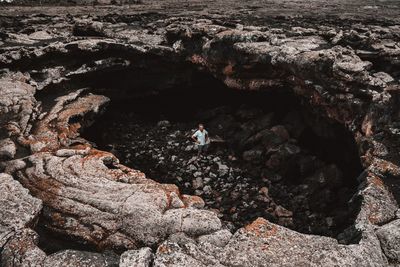 High angle view of man standing in cave