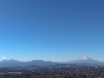 Scenic view of mountains against clear blue sky