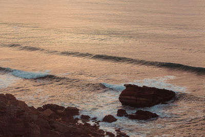 High angle view of rocks on sea shore