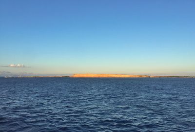 Scenic view of sea against clear blue sky