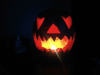 Close-up of illuminated pumpkin against black background