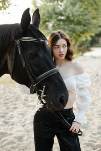 Portrait of young woman riding horse