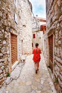 Full length of woman walking on sidewalk