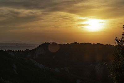 Scenic view of silhouette mountains against sky during sunset