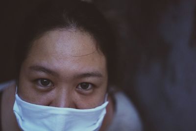 Close-up portrait of woman wearing mask