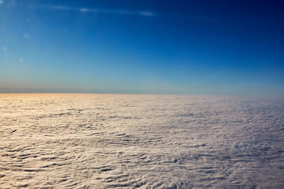 Scenic view of sea against clear blue sky