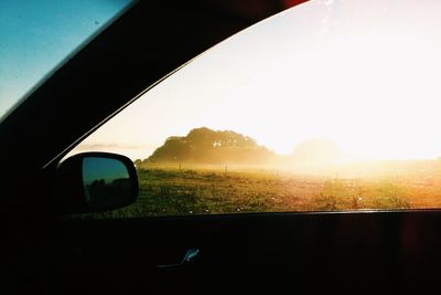 Car on road against clear sky during sunset