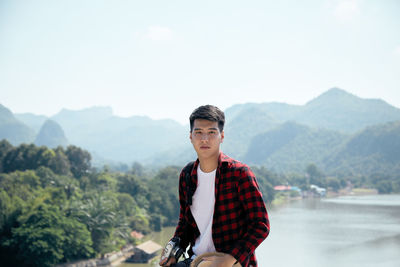 Portrait of man against mountains against sky