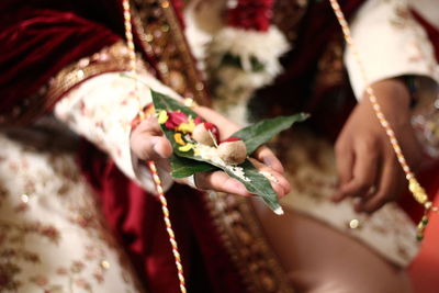 Midsection of woman holding flower bouquet