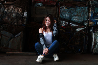 Portrait of smiling young woman sitting outdoors