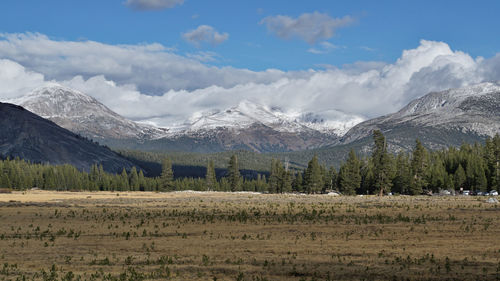 Scenic view of field and mountains against sky