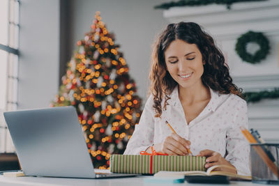 Young woman using laptop at home
