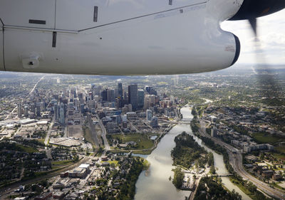 Propeller airplane flying over cityscape