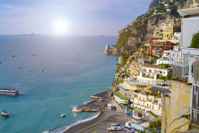 High angle view of sea and buildings against sky