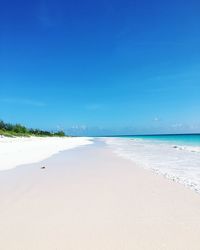 View of beach against clear blue sky