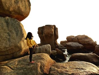 Woman standing on rock formation