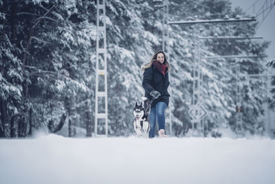 Full length of woman on snow covered land