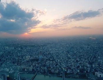 High angle shot of townscape against sky at sunset