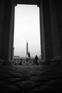 Low angle view of people at historical building