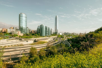 Aerial view of modern buildings in city against sky