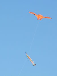 Low angle view of helicopter flying in sky