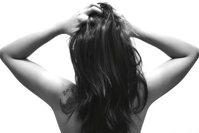 Close-up of young woman against white background