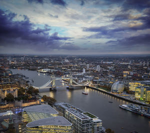 High angle view of river amidst buildings in city against sky