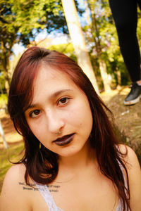Close-up portrait of young woman in park