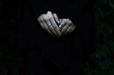 Close-up mid section of a woman with hands clasped