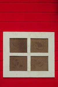 Full frame shot of window on red wall