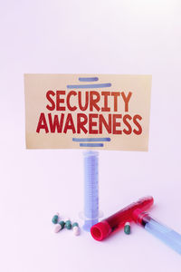 Close-up of information sign against white background