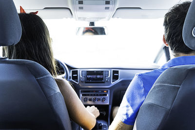 Happy couple driving a car