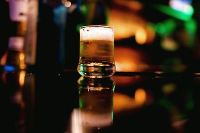 Close-up of wine glasses on table