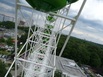 Low angle view of chain swing ride against sky