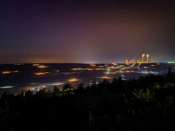 High angle view of illuminated buildings in city at night