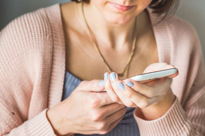 Midsection of woman using smart phone