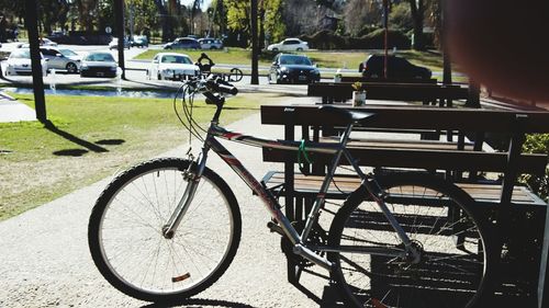 Bicycle parked by tree